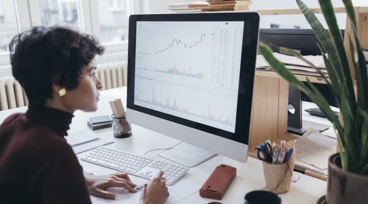 Businessfrau schaut sich Graphen auf ihrem Bildschirm an