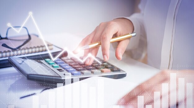 Accountant calculating profit with financial analysis graph
